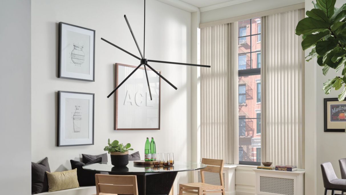 Vertical window treatments in kitchen with urban view