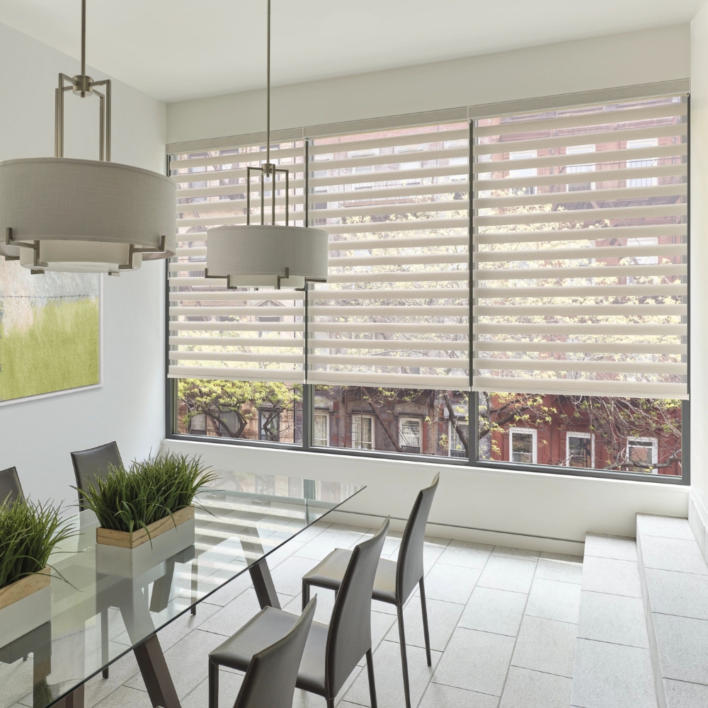 Banded shades open in kitchen with view to outside tree building