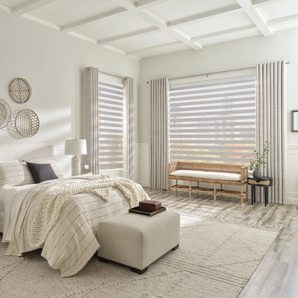 Open banded shades in bedroom with side panel curtains shows view to the city