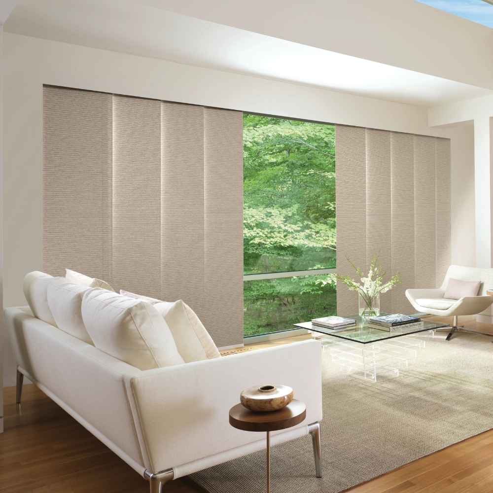 Wide fabric panels partially open in living room with garden view