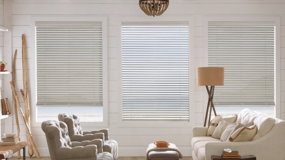 Faux wood Blinds in living room with side windows 20% open and middle window with open blinds, blinds are white