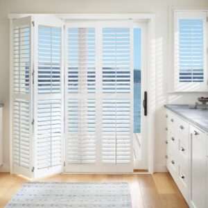 sliding bi-fold white vinyl shutters on patio door 10% folded open, shutters are open with beach view