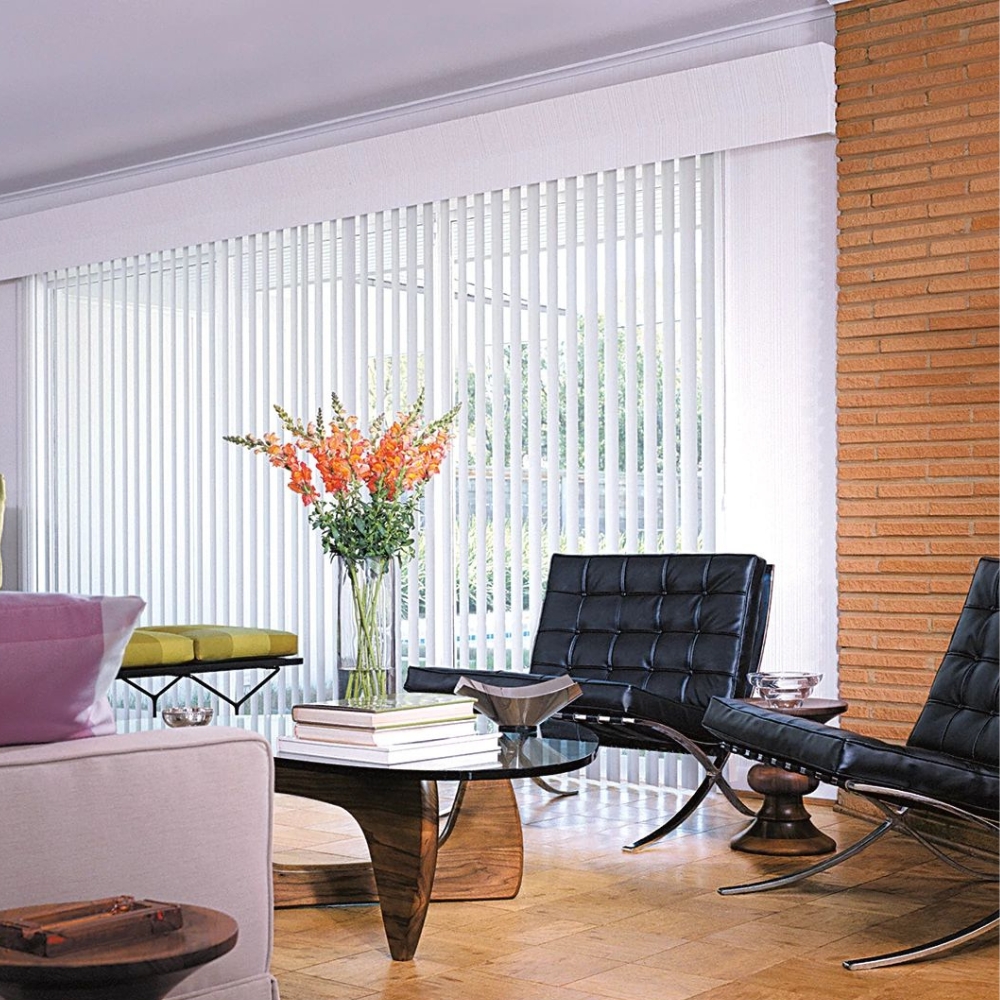 vertical blinds open in a living room with two leather chairs and a coffee table vase with flower