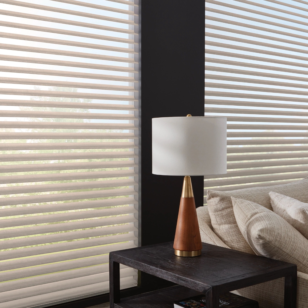 Hunter Douglas taupe nantucket sheer shades open in living behind side table with lamp beside sofa