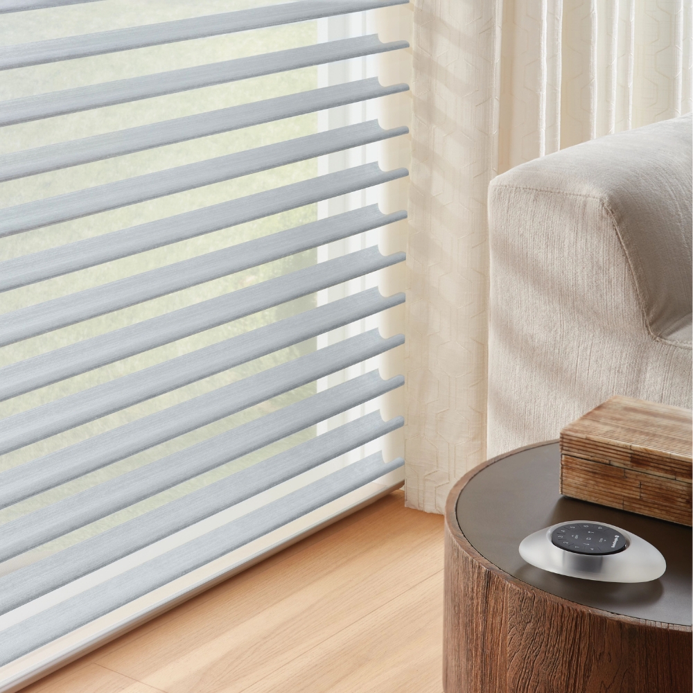 Hunter Douglas white nantucket sheer shades open in living room with remote control for motorized shades