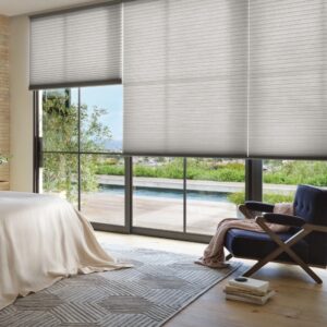 Bedroom with cellular shades partially open featuring alustra fabric