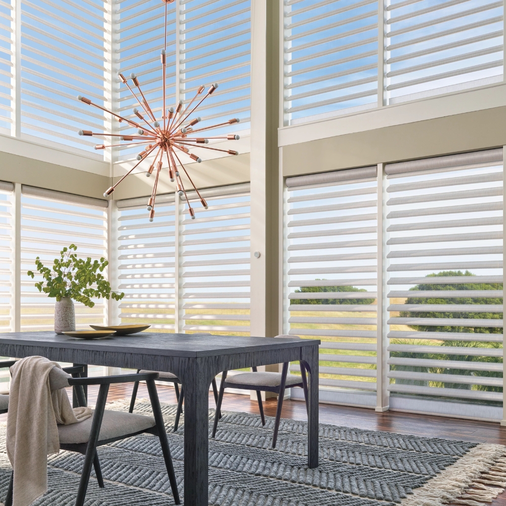 open Pirouette alustra shades on tall windows behind kitchen table