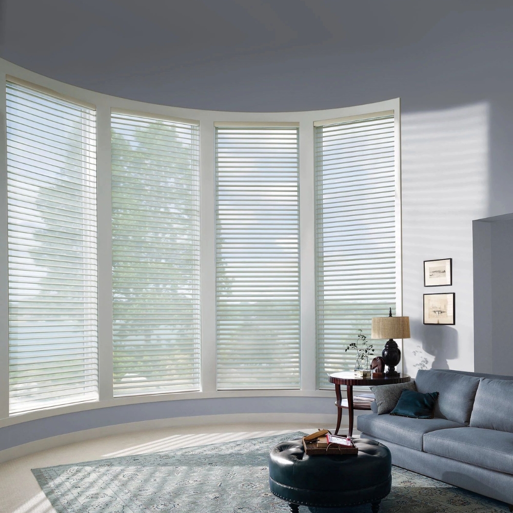 sheer window shades covering a bay window in a living room, shades are open.