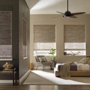 Bedroom with Independent liner behind semi sheer woven wood shade partially open with city view