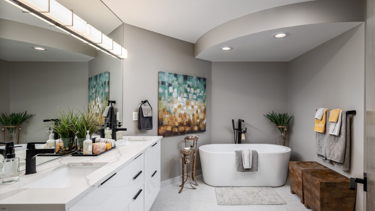 bathroom vanity and tub with lighting