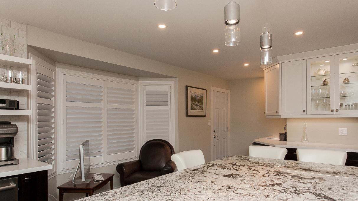 kitchen island and sitting area with window shutters after reno St.Albert