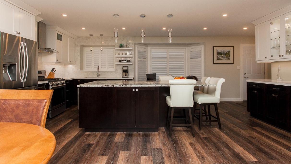 kitchen island and sitting area with window shutters after reno St.Albert